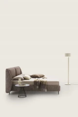 Timoty — Wingback bed with a padded structure.