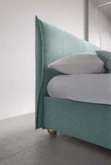 Hesperis — Space-saving bed with a simple, curved padded headboard.