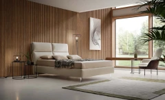 King — Modern bed with a wide headboard composed of two large vertical cushions split in the middle.