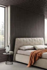 Atrium — Bed with quilted headboard featuring contrasting "X" stitching.