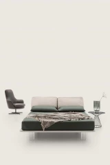 Fenice — Bed with a headboard made of soft upholstered cushions.