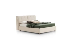 Inside — Bed with a tufted headboard and a built-in storage compartment.