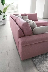 Papilio — Sofa with extendable footrest, rounded armrests, and asymmetrical corner seating.