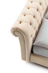 Raffaello — Classic-style bed with a rolled-top tufted headboard.