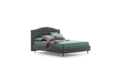 Renoir — Classic-style bed with a tall, curved headboard featuring full-width tufting.