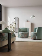 Isabel — Round-based barrel-like design armchair with a sleek backrest and perimeter stitching.