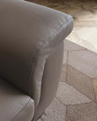 Zeno — Modern recliner sofa with adjustable headrests in a curved, enveloping design.