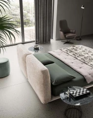 Fenice — Bed with a headboard made of soft upholstered cushions.