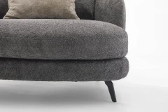 Jand — Sofa with organic shapes, high legs, round end modules, and shaped seats