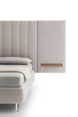 Tile — Contract bed with a vertical padded headboard and side panels with built-in shelves.