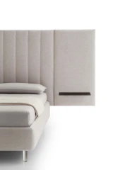 Tile — Contract bed with a vertical padded headboard and side panels with built-in shelves.