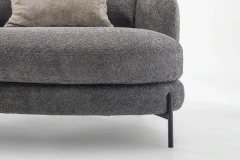 Jand — Sofa with organic shapes, high legs, round end modules, and shaped seats
