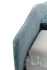Rosa — Classic-style bed with a smooth, rounded upholstered headboard and decorative trim.