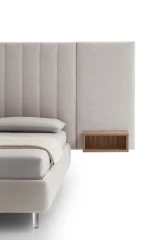 Tile — Contract bed with a vertical padded headboard and side panels with built-in shelves.