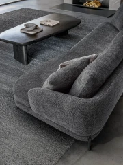 Jand — Sofa with organic shapes, high legs, round end modules, and shaped seats