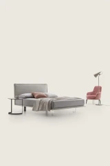 Vasco — Space-saving bed with a smooth padded headboard and piping detail.
