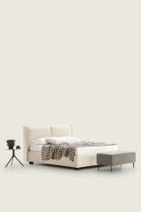 Windsor — Bed with a padded headboard composed of two delicately designed cushions.