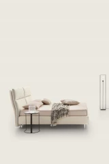 King — Modern bed with a wide headboard composed of two large vertical cushions split in the middle.