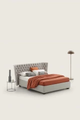 Caravaggio — Classic-style wingback bed with tufted headboard.