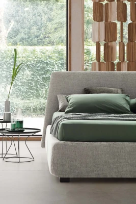 Calvin — Bed with a simple design featuring a softly rounded and smooth upholstered headboard.