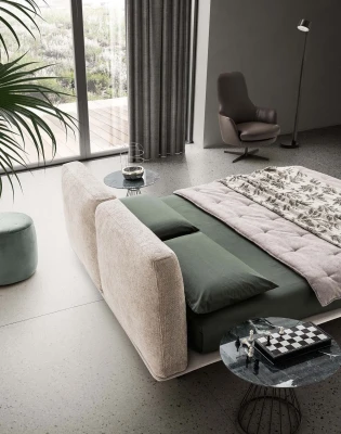 Fenice — Bed with a headboard made of soft upholstered cushions.