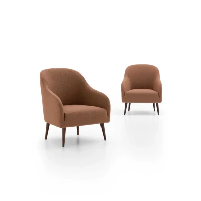 Adda — Simple armchair with soft, welcoming lines and high legs.