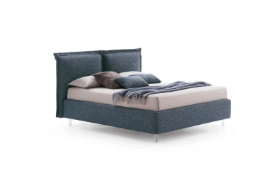 Catlin — Bed with a headboard composed of padded cushions with wide borders.
