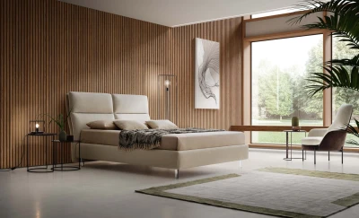 King — Modern bed with a wide headboard composed of two large vertical cushions split in the middle.