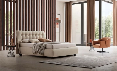 Guscio — Bed with a tufted headboard in a classic capitonne style.