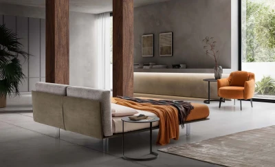 Essential — Bed with a headboard made of cushions resting on a semi-rigid panel.
