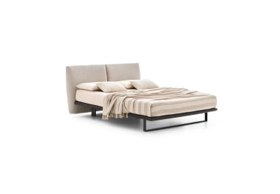 Monaco — Modern bed with a large headboard composed of upholstered cushions.