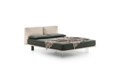 Fenice — Bed with a headboard made of soft upholstered cushions.