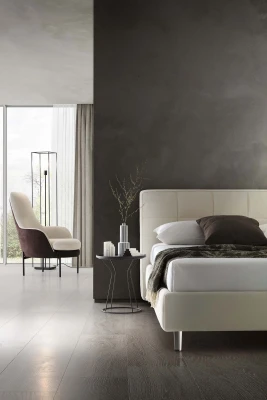 Gaucho — Bed with a squared headboard featuring a quilted square motif.