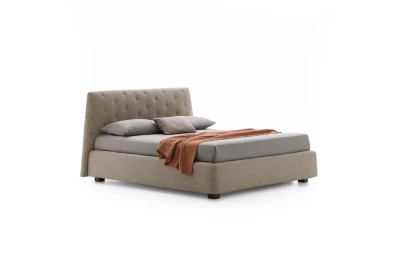 Atrium — Bed with quilted headboard featuring contrasting "X" stitching.