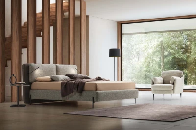 Cortina — Bed with a cushioned headboard wrapping around the structure and a USB port for optional LED lights.