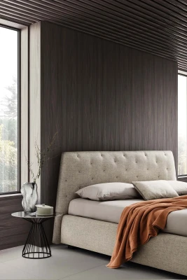 Atrium — Bed with quilted headboard featuring contrasting "X" stitching.