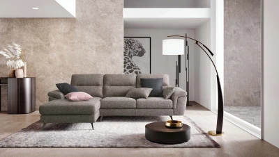 Cupido — Sofa with extendable footrest, asymmetrical corner seating, and rounded armrests.