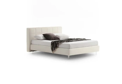 Gaucho — Bed with a squared headboard featuring a quilted square motif.